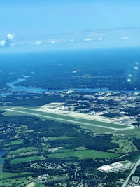 an aerial view of an airport with a runway in the background
