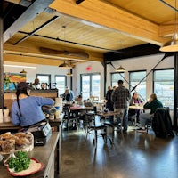 a group of people sitting at tables in a restaurant