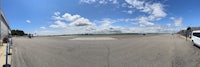 a fish eye view of an airport with a van parked on the tarmac