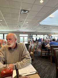 a man sitting at a table in a restaurant