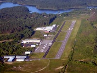 an aerial view of an airport near a lake