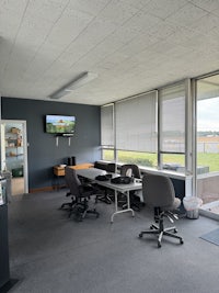 an office with several desks and a tv