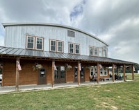 a building with a metal roof and a flag on it