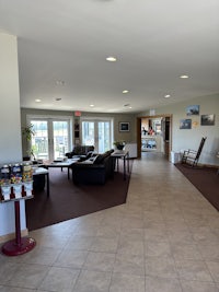 a lobby with a lot of tables and chairs