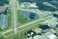 an aerial view of an airport with solar panels