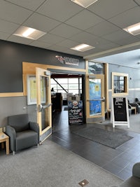the lobby of a building with a desk and chairs