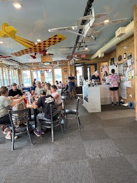 a group of people sitting at a table in a restaurant