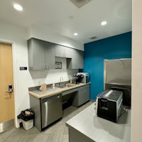 a small kitchen with a microwave and refrigerator