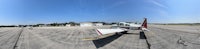 a fish eye view of an airplane parked on a runway