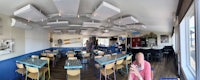 the inside of a restaurant with tables and chairs