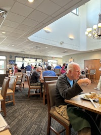 a group of people sitting at a table in a restaurant