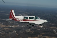 a small plane flying over a city