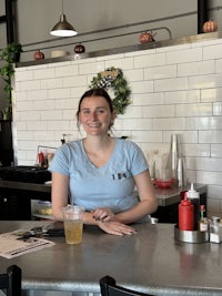 a woman sitting at a counter in a restaurant
